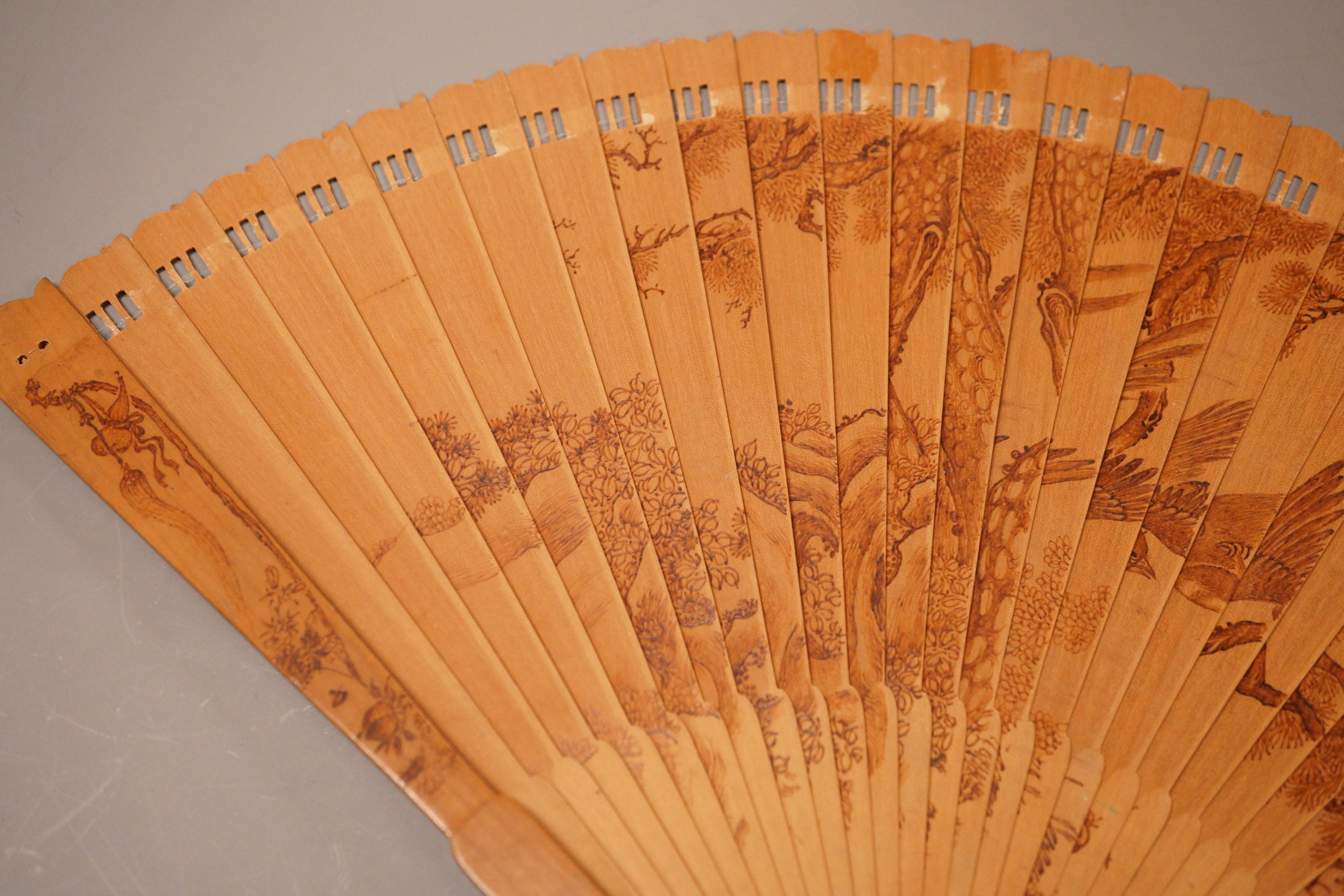 A Chinese penwork sandalwood fan